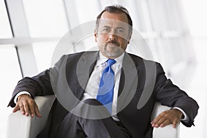 Businessman sitting in chair in lobby