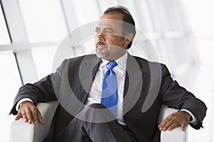 Businessman sitting in chair in lobby