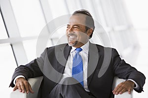 Businessman sitting in chair in lobby