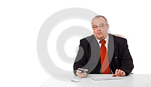 businessman sitting at desk and holding a mobilephone with copys pace