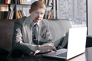 Businessman sitting at desk with laptop