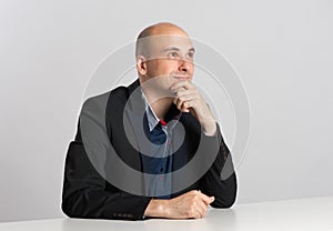 Businessman sitting at the desk and thinking
