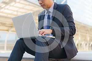 Businessman sitting on the footsteps