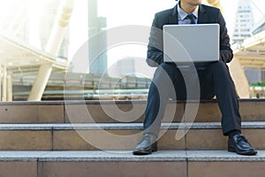 Businessman sitting on the footsteps