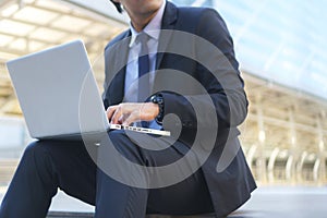 Businessman sitting on the footsteps