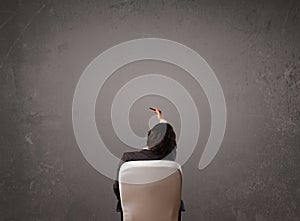 Businessman sitting in front of a wall with copy space