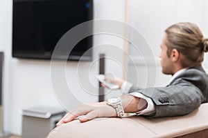 Businessman sitting at home and turning