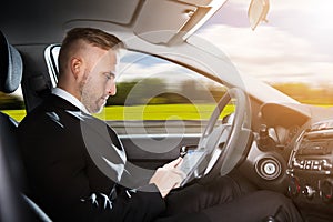 Businessman Sitting Inside Self Driving Car