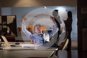 Businessman sitting with legs on desk at office