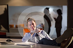 Businessman sitting with legs on desk at office