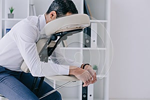 businessman sitting in massage chair