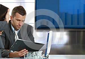 Businessman sitting at meeting table