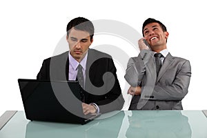 Businessman sitting next to colleague photo