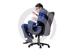 The businessman sitting on office chair isolated on white