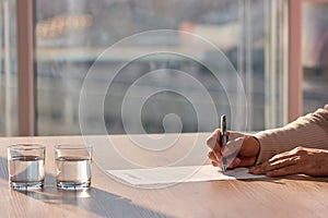 Businessman sitting at office desk and signing a contract.