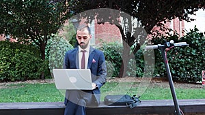 Businessman sitting ouside in front on startup building office working at business presentation