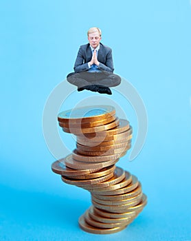 Businessman sitting on the pile of money