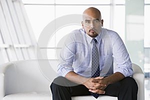 Businessman sitting on sofa in lobby