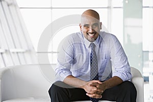 Businessman sitting on sofa in lobby