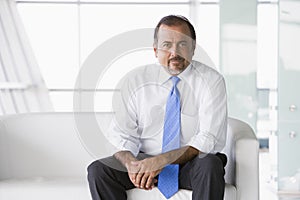 Businessman sitting on sofa in lobby