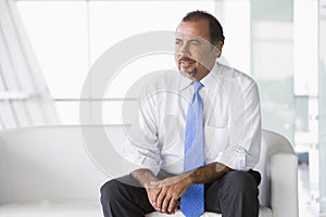 Businessman sitting on sofa in lobby