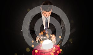 Businessman  sitting with sparkling magic ball