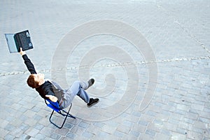 Businessman sitting at the street