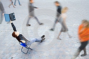 Businessman sitting at the street