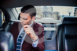 Businessman sitting in stretch limo