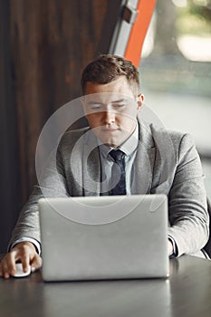Businessman sitting at thecafe with laptop