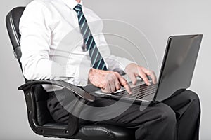 Businessman sitting and typing on his laptop