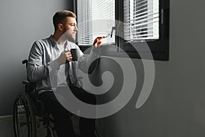 Businessman sitting on wheelchair at hospital. Sad disabled at the hospital