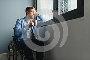 Businessman sitting on wheelchair at hospital. Sad disabled at the hospital.