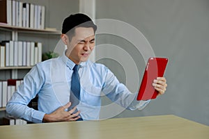 Businessman sitting workspace stomach pain due to gastritis in office