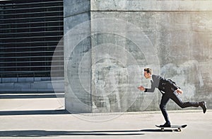 Businessman on a skateboard moving forward fast