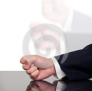 A businessman slamming his fist on a table