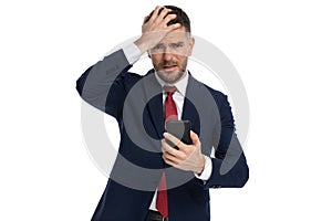 Businessman slapping his head seeing what text he received