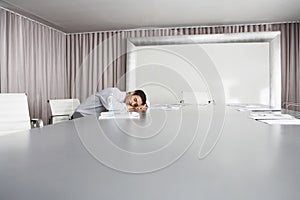 Businessman Sleeping In Conference Room