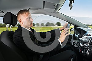 Businessman sleeping while driving car