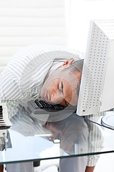 Businessman sleeping on a keyboard