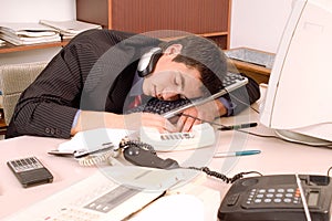 Businessman sleeping at office photo