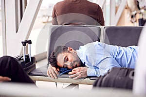 Businessman Sleeping On Seats In Airport Departure Lounge Because Of Delay