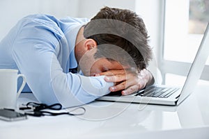 Businessman, sleeping and tired at work, burnout and exhausted or mental health, desk and overwhelmed. Male person