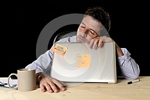 Businessman sleeping wasted tired at office computer desk in long hours of work