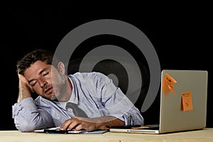 Businessman sleeping wasted tired at office computer desk in long hours of work