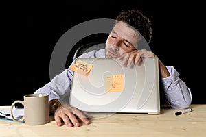 Businessman sleeping wasted tired at office computer desk in long hours of work photo