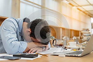 Businessman is sleeping while working. Tired man sleeping during work hours