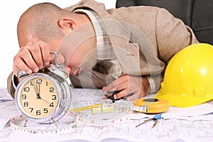 A businessman sleepy with architectural plans