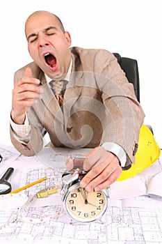 A businessman sleepy with architectural plans