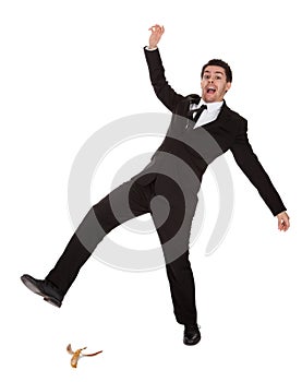 Businessman slipping on banana peel